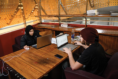 Two students on their laptops. Links to Gifts by Will