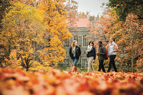 Students walking outside on a fall day. Links to Closely Held Business Stock