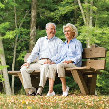 A couple sitting on a bench. Links to Gifts of Appreciated Securities